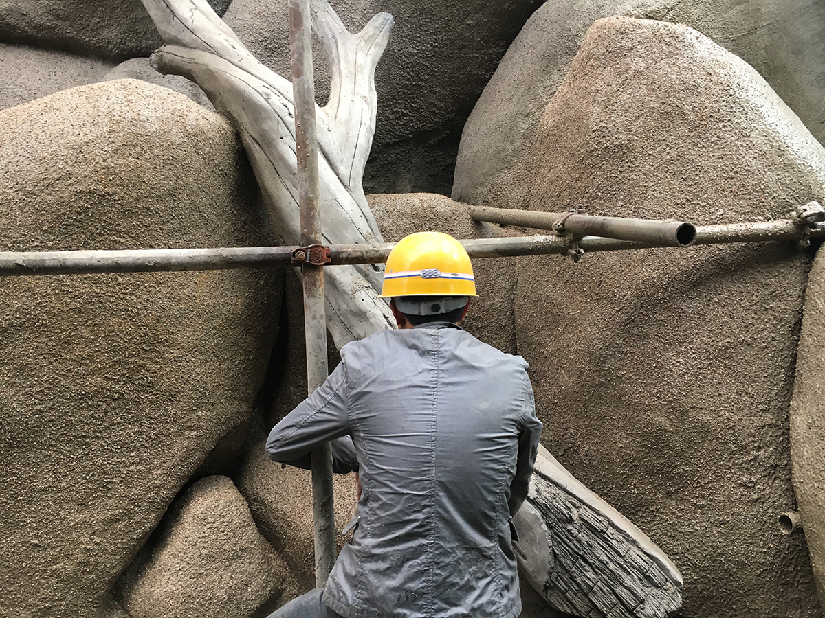 Artificial coral reef installation in progress with scaffolding in large aquarium