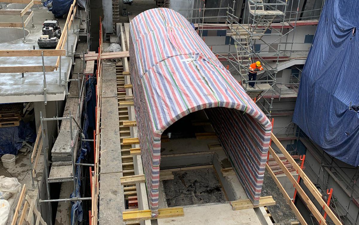 Acrylic underwater tunnel pre-install panel layout — curved PMMA segments arranged on site before lifting sequence begins